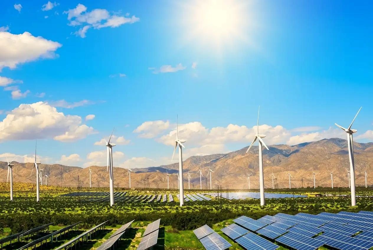 Wind turbines and solar panels on a sunlit farm