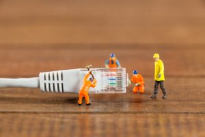 wp-content-uploads-2025-06-miniature-engineer-workers-working-with-lan-cable-300x200